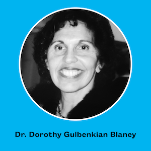 Black and white headshot of Dr. Dorothy Gulbenkian Blaney against a blue background with text that reads "Dr. Dorothy Gulbenkian Blaney"